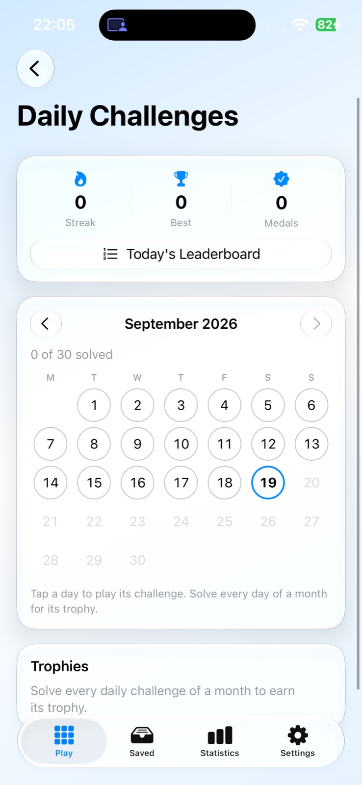 Daily Challenges calendar on iPhone for September 2026 with streak, best and medal counters, a Today's Leaderboard link, and a Trophies section
